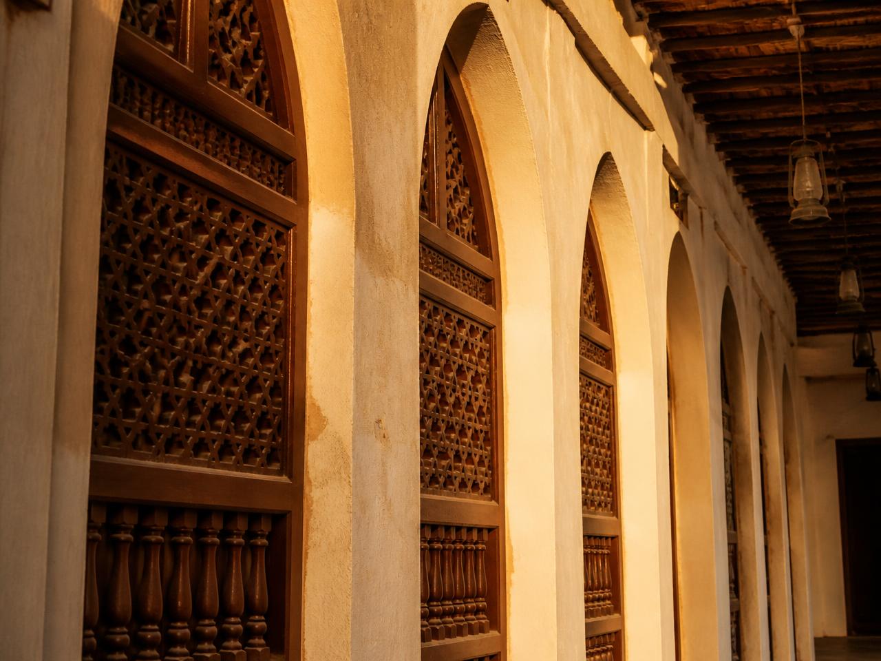 Carved wooden mashrabiya screens and arches at Souq Waqif in Doha